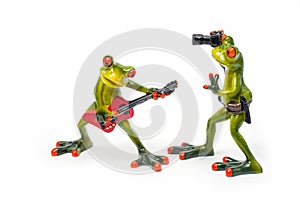 Decorative figures of frogs, a frog with a red guitar and a frog with a camera