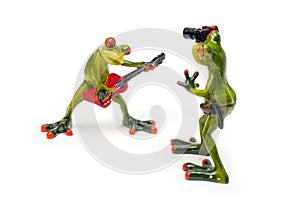 Decorative figures of frogs, a frog with a red guitar and a frog with a camera