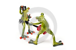 Decorative figures of frogs, a frog with a red guitar and a frog with a camera
