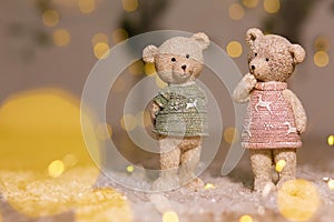 Decorative figurines of a Christmas theme. Figurines of cute teddy bears of a boy and a girl in sweaters with deers. Festive decor