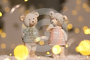 Decorative figurines of a Christmas theme. Figurines of cute teddy bears of a boy and a girl in sweaters with deers. Festive decor
