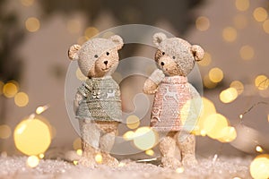 Decorative figurines of a Christmas theme. Figurines of cute teddy bears of a boy and a girl in sweaters with deers. Festive decor