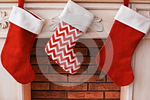 Decorative fireplace with Christmas stockings indoors