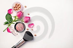 Decorative flat lay composition with cosmetics and flowers. Flat lay on white background