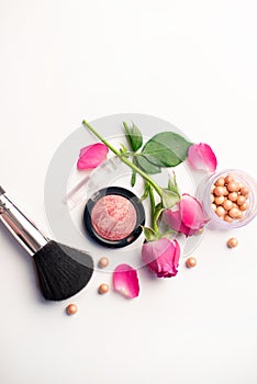 Decorative flat lay composition with cosmetics and flowers. Flat lay on white background