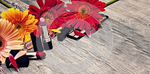 Decorative flat lay composition with cosmetics and flowers. white background