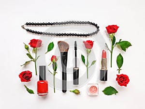 Decorative flat lay composition with cosmetics and red rose flowers. Flat lay, top view