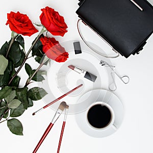 Decorative flat lay composition with cosmetics, women's accessories and flowers. Flat lay, top view on white