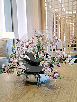 Decorative flowers look beautiful in ceramic vases.  Placed on the table to beautify the living room photo