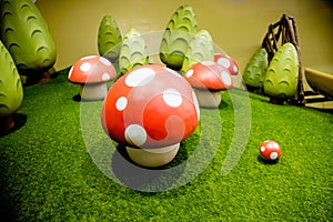 Decorative fly agaric on a green lawn.red mushrooms decoration.many mushrooms, big toys ,ornament.Fairy forest with