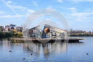 Decorative fountain on Plumbuita lake (Lacul Plumbuita) and park, in Bucharest, Romania, in a sunny autumn day with