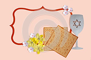 Decorative frame with matzo bread, wine glass and flowers for Passover