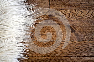 Decorative fur carpet on wood floor