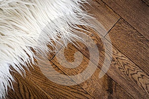 Decorative fur carpet on wood floor