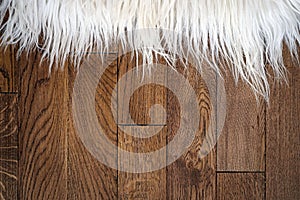 Decorative fur carpet on wood floor