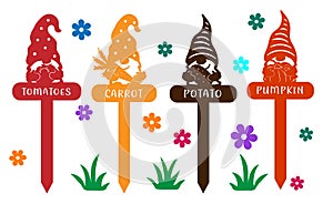 Decorative garden and garden toppers with gnomes and vegetables. Signs with carved elements