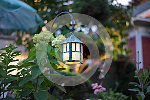 Decorative garden lantern with amber glow