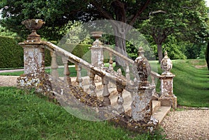 Decorative garden steps with a balustrade, urns, & globes.