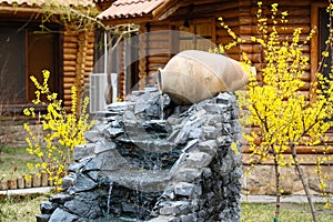 Decorative garden waterfall with stone jar