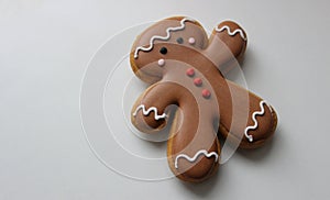 Decorative Gingerbread Man With Chocolate Icing On A White Surface Top View