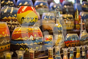 Decorative glass bottles with colored sand inside making shapes of desert and camels