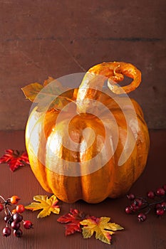 Decorative golden papier-mache pumpkin and autumn leaves for hal
