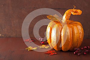 Decorative golden papier-mache pumpkin and autumn leaves for hal