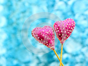 Decorative hand made hearts on sky background