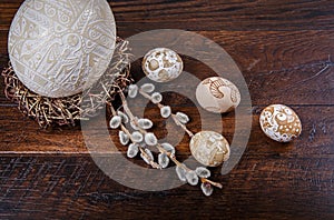 Easter eggs in a nest on a wooden