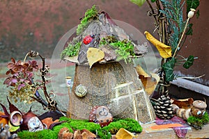 Decorative handmade house surrounded by figures of animals