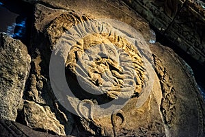 Decorative head from the temple pediment at Roman Baths, Bath, England