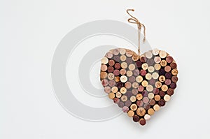 Heart made of wine corks isolated on white wall