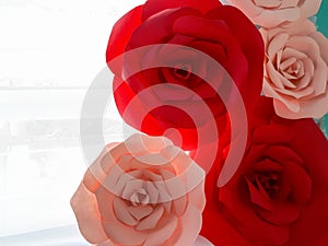 decorative illuminated paper flowers in red and pink colors with white background