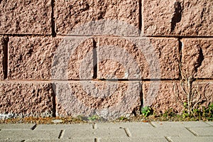 Decorative imitation of pink brickwork - the wall of the house and the sidewalk. Background