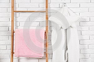 Decorative ladder with clean towel and robe