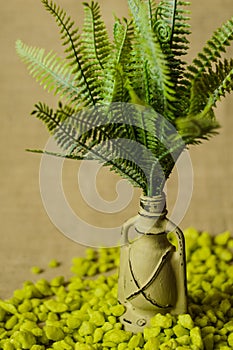 Decorative lamp with ferns and green stone top view.