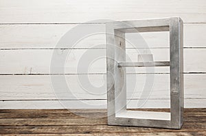 A decorative lamp made of wood stands on a wooden table. Texture