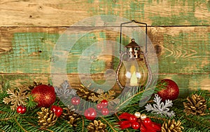 Decorative  lantern with a burning candle in a christmas composition on a wooden background