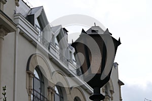 A decorative lantern installed next to the house with a 1st ceiling.