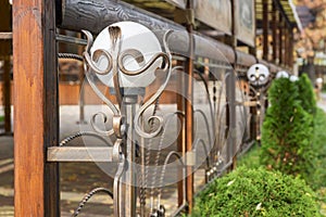 Decorative lanterns along the street cafe barrier. Front of street cafe. Modern european cafe