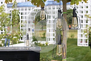 Decorative lanterns with lamps hanging on street