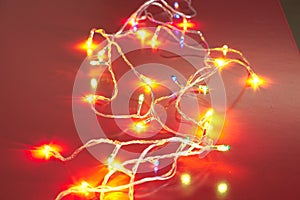 Decorative LED bulbs with a variety of colors and flashes on a red background