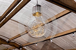 Decorative lighting inside a bulb hung to a ceiling