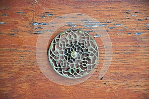 Decorative metal detail on a wooden wall