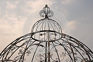 DECORATIVE METAL DOME AGAINST CLOUDY SKY