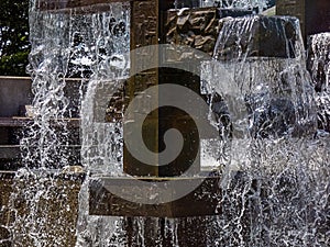 Decorative metal fountain with falling clear water