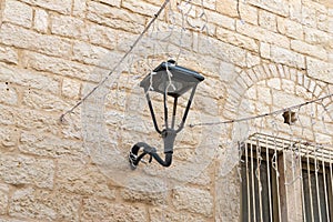Decorative  metal street lamp hanging on the wall of a building on Star Street in Bethlehem in the Palestinian Authority, Israel