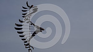 Decorative modern spinning weather vane in the backyard