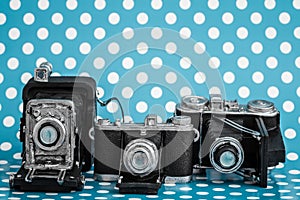Decorative Old Antique Cameras on Blue Background