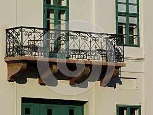 Decorative old stone balcony in low level view on multi level classic white building